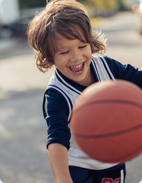 Little boy playing basketball