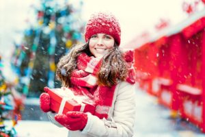 Woman with Invisalign holding holiday gift