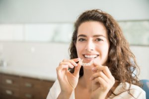 woman removing Invisalign in Greenfield